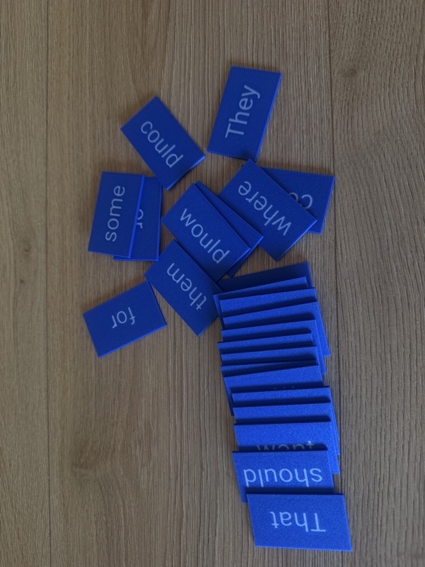 Spread of word tiles showing various words
